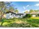 Back exterior showing a patio, shed, and a well-maintained lawn with mature trees at 3685 Concordia Rd, Decatur, GA 30034