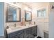 Contemporary bathroom with dual sinks, gray cabinetry, and ample storage space at 3685 Concordia Rd, Decatur, GA 30034