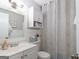 Bright bathroom with a vanity, a toilet, and shower featuring a patterned curtain at 3685 Concordia Rd, Decatur, GA 30034