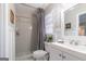 Simple bathroom featuring a vanity sink, tiled shower, and a decorative mirror at 3685 Concordia Rd, Decatur, GA 30034