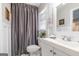 Clean bathroom with a vanity sink, decorative mirror, and a shower with a curtain at 3685 Concordia Rd, Decatur, GA 30034