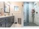 Modern bathroom featuring a vanity and walk-in shower with decorative tiling at 3685 Concordia Rd, Decatur, GA 30034