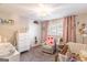 Charming Bedroom with a crib, dresser, and a soft armchair, perfect for a baby at 3685 Concordia Rd, Decatur, GA 30034