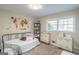 Neutral bedroom featuring natural light, a comfortable bed, and stylish furnishings at 3685 Concordia Rd, Decatur, GA 30034