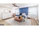 Bright bedroom featuring a large bed with a blue accent wall and modern decor at 3685 Concordia Rd, Decatur, GA 30034