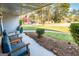 Inviting front porch with comfortable blue seating and a view of the landscaped front yard at 3685 Concordia Rd, Decatur, GA 30034