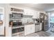 Updated kitchen with stainless steel appliances, granite countertops, and white cabinetry at 3685 Concordia Rd, Decatur, GA 30034