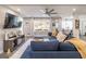 Bright living room featuring a blue sofa, large window, and an open floor plan at 3685 Concordia Rd, Decatur, GA 30034