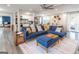 Open-concept living room with a cozy blue sectional, hardwood floors, and modern decor at 3685 Concordia Rd, Decatur, GA 30034