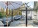 Back patio with comfortable seating including chairs and a couch under a pergola with a patio heater at 3685 Concordia Rd, Decatur, GA 30034