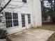 Backyard patio with a white house featuring a door and large windows at 50 Village Walk, Covington, GA 30016