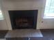 Close-up of the fireplace with white mantle, dark firebox, and tile hearth at 50 Village Walk, Covington, GA 30016