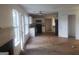 Open concept living room adjacent to the kitchen featuring a fireplace and large windows at 50 Village Walk, Covington, GA 30016