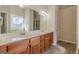Bathroom featuring double sinks with granite counters, vanity, and updated fixtures at 4050 Villagewood Ln, Ellenwood, GA 30294