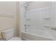 Bathroom features a combined shower and tub with a hand shower and a neutral-colored tiled floor at 4050 Villagewood Ln, Ellenwood, GA 30294