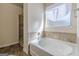 Bright bathroom with a soaking tub and shower at 4050 Villagewood Ln, Ellenwood, GA 30294
