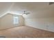 An attic bonus room with carpet, ceiling fan, window and utility access at 4050 Villagewood Ln, Ellenwood, GA 30294
