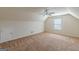 A spacious carpeted room with vaulted ceiling, a window, and a ceiling fan at 4050 Villagewood Ln, Ellenwood, GA 30294