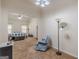 Open bedroom with a comfortable chair, neutral paint, and large windows at 4050 Villagewood Ln, Ellenwood, GA 30294