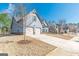 Home exterior with a two-car garage, manicured lawn, and a cozy neighborhood feel at 4050 Villagewood Ln, Ellenwood, GA 30294