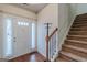 Entryway with hardwood floors, a coat rack, staircase, and natural light at 4050 Villagewood Ln, Ellenwood, GA 30294
