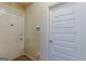 Hallway view of interior featuring white doors and a thermostat at 4050 Villagewood Ln, Ellenwood, GA 30294