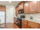 Well-equipped kitchen with granite countertops, wood cabinets, and stainless appliances at 4050 Villagewood Ln, Ellenwood, GA 30294