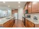 Modern kitchen featuring granite countertops, wood cabinets, and stainless steel appliances at 4050 Villagewood Ln, Ellenwood, GA 30294