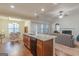 Contemporary kitchen with island, granite countertops, and seamless flow to dining and living spaces at 4050 Villagewood Ln, Ellenwood, GA 30294