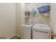 Laundry area with modern side-by-side appliances and shelving at 4050 Villagewood Ln, Ellenwood, GA 30294