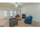 Bright living room with a fireplace, ceiling fan, and comfortable seating arrangement at 4050 Villagewood Ln, Ellenwood, GA 30294