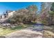 A sidewalk stretches alongside lush greenery leading to a charming home, inviting for a peaceful stroll in the neighborhood at 4050 Villagewood Ln, Ellenwood, GA 30294