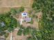 Expansive aerial view of a property with a pool, surrounded by lush greenery and mature trees at 245 Jewel Blf, Fayetteville, GA 30214