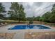 Beautiful backyard featuring a refreshing in-ground pool and scenic views of open fields at 245 Jewel Blf, Fayetteville, GA 30214
