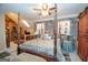 Spacious bedroom features a four-poster bed, stone accents, and ample natural light at 245 Jewel Blf, Fayetteville, GA 30214