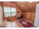 Bright bonus room featuring natural wood walls, window, and seating at 245 Jewel Blf, Fayetteville, GA 30214