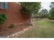 Exterior side view with brick detail, landscaping, and private yard at 245 Jewel Blf, Fayetteville, GA 30214