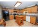 Bright and functional kitchen features ample counter space, cabinets, and island, and stainless appliances at 245 Jewel Blf, Fayetteville, GA 30214