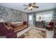 Cozy living room with stone accent wall, ceiling fan, and comfortable seating at 245 Jewel Blf, Fayetteville, GA 30214