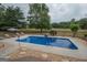 Refreshing in-ground pool with adjacent lounge area, surrounded by lush greenery at 245 Jewel Blf, Fayetteville, GA 30214