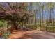 Relaxing back deck features a beautiful flowering tree and fenced in yard for the perfect spot to enjoy nature at 65 Dundee Pl, Sharpsburg, GA 30277