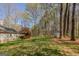 Backyard view highlighting the expansive yard, mature trees, storage shed, and outdoor living space at 65 Dundee Pl, Sharpsburg, GA 30277