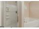Bathroom featuring a glass shower, a bathtub, and a small window at 65 Dundee Pl, Sharpsburg, GA 30277