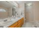 Bright bathroom featuring double sinks, a large mirror, and a separate toilet area at 65 Dundee Pl, Sharpsburg, GA 30277