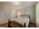 Cozy bedroom with a wrought iron bed frame and a window for natural light at 65 Dundee Pl, Sharpsburg, GA 30277