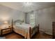 Bedroom featuring a comfortable bed, a side table with a lamp, and natural light at 65 Dundee Pl, Sharpsburg, GA 30277