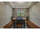 Cozy dining room with decorative trey ceiling, neutral walls and wood floors at 65 Dundee Pl, Sharpsburg, GA 30277