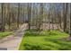 Home exterior featuring a long driveway and meticulously maintained landscaping at 65 Dundee Pl, Sharpsburg, GA 30277
