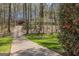 Charming home with a long driveway, mature trees, and meticulous landscaping at 65 Dundee Pl, Sharpsburg, GA 30277