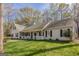 Attractive home with covered porch, black shutters, and well-manicured lawn, offering a welcoming curb appeal at 65 Dundee Pl, Sharpsburg, GA 30277